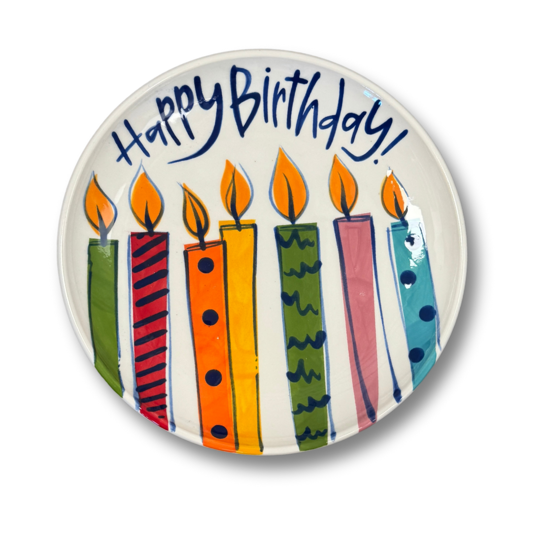 Ceramic plate with colorful candles and 'Happy Birthday!' text on a white background