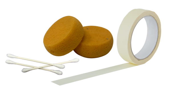 Two yellow sponges, a roll of tape, and cotton swabs on a white background